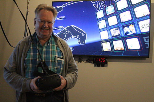 President of The Grid VR Arcade, Rob Bryanton holds the HTC Vive Virtual Reality System. Along with hand controllers, the Vive allows the user to experience interactive virtual reality. 