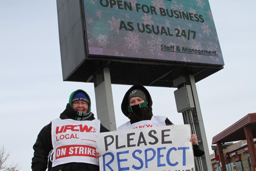 Laureen Smith (pictured left) stands with a union representative on the picket line.