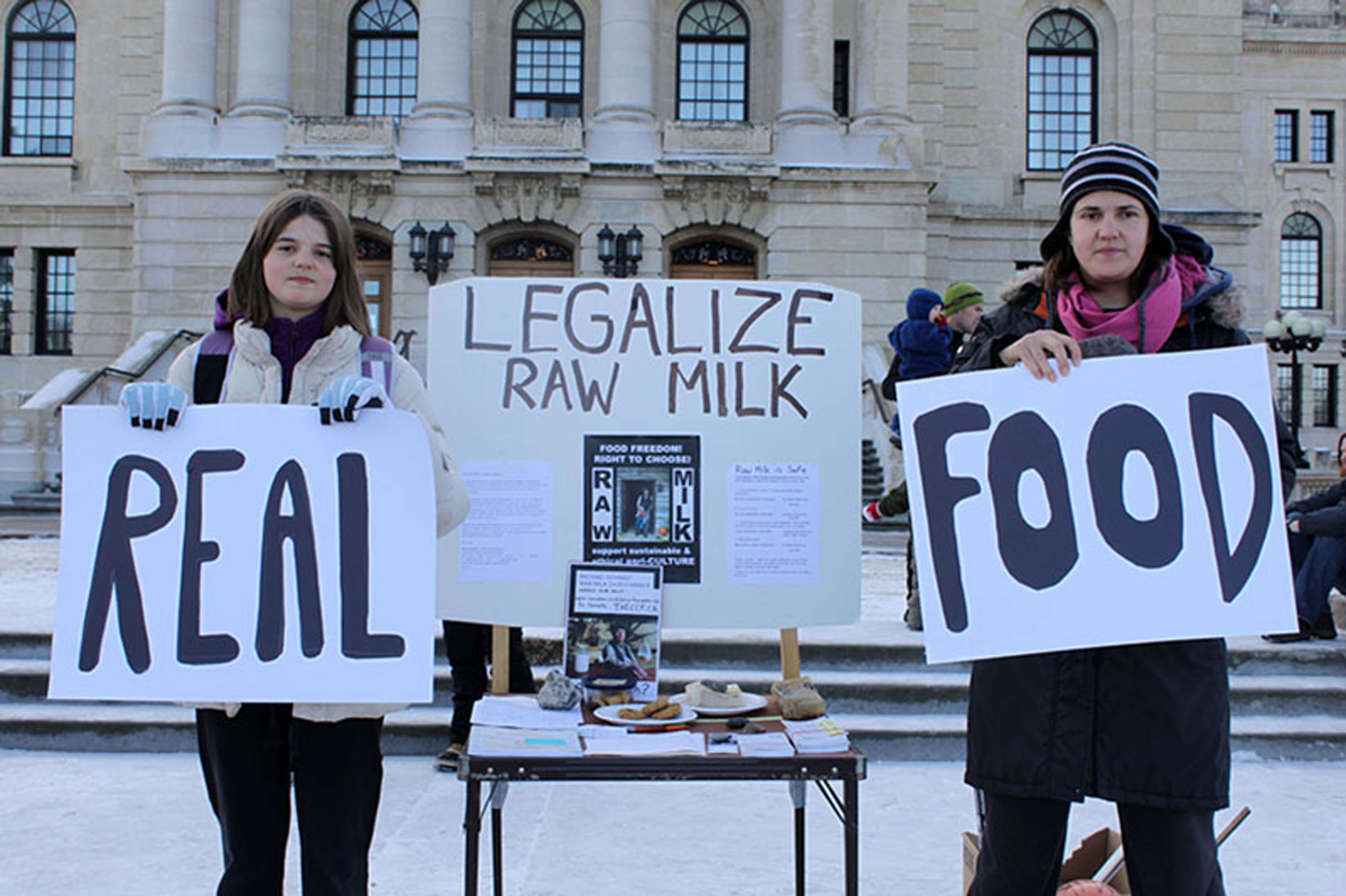 Raw milk drinkers Emily Kutarna (left) and Jana Kutarna (right) at the Food Freedom Rally in Regina on Nov. 23. Photo by Christeen Jesse.